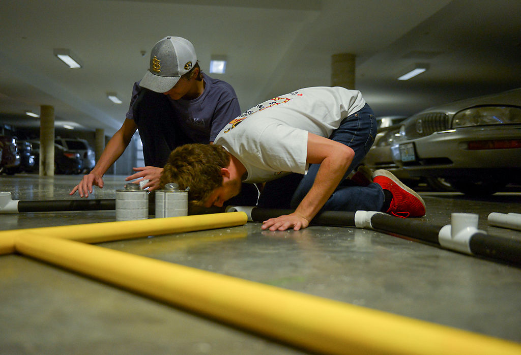 Derek Fleffner, left, and Mason Karpinske glue PVC pipes together